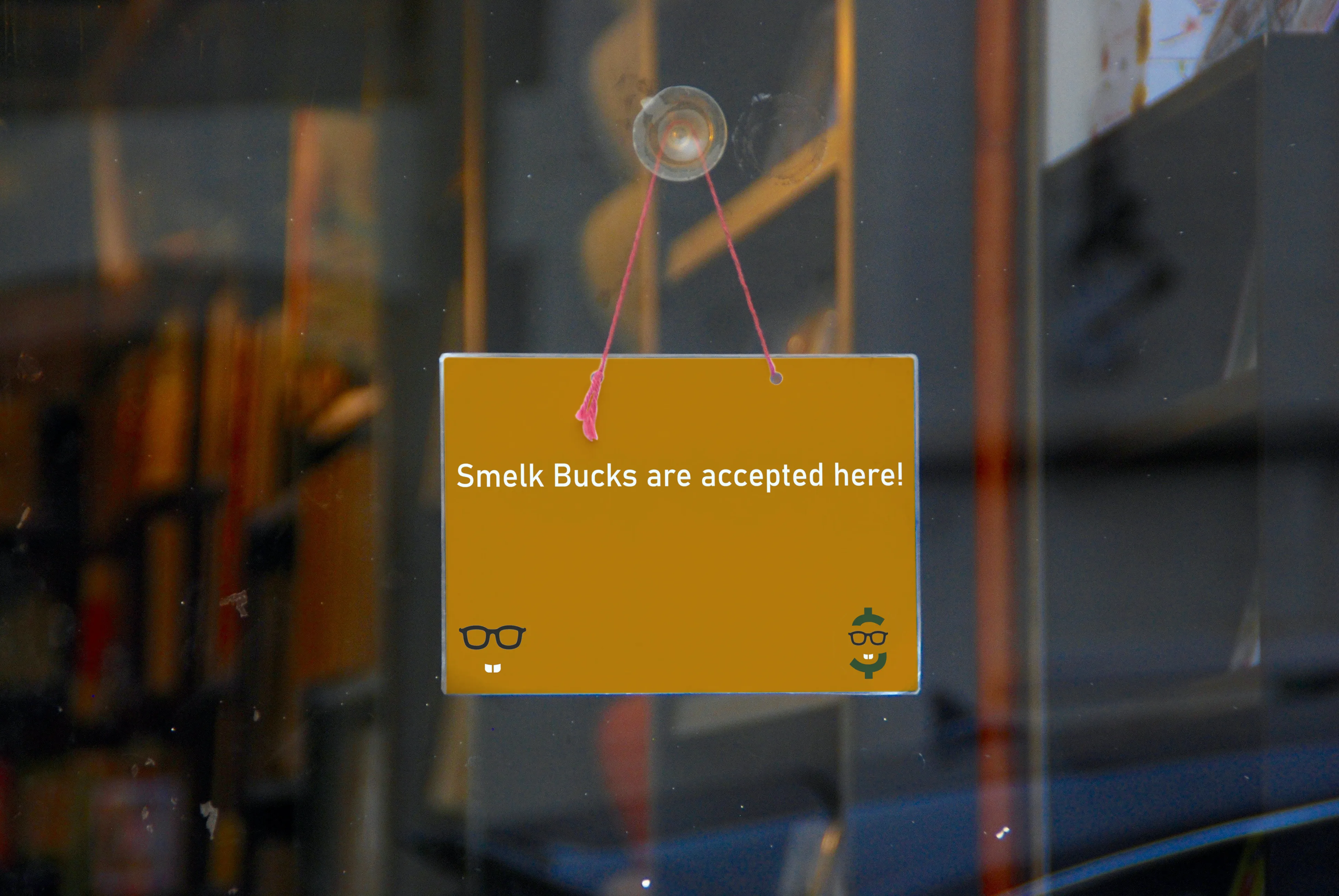 A store displaying a sign signifying their acceptance of Smelk Bucks as currency